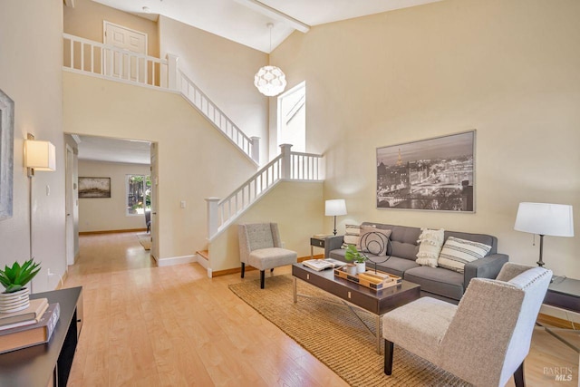 119 Philip Dr, Healdsburg, CA 95448 - living area featuring high vaulted ceiling, wood finished floors, stairs, and baseboards