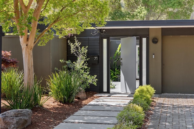 doorway to property featuring fence