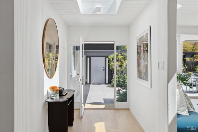 entryway featuring baseboards and light wood-style floors