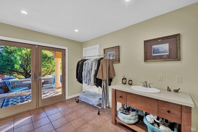 bathroom with tile patterned flooring, french doors, vanity, and recessed lighting