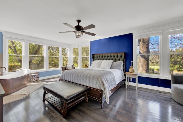 bedroom featuring baseboards, a ceiling fan, dark wood-type flooring, and visible vents