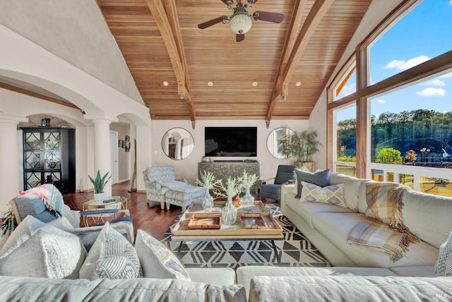 living room featuring arched walkways, wood finished floors, wooden ceiling, and decorative columns