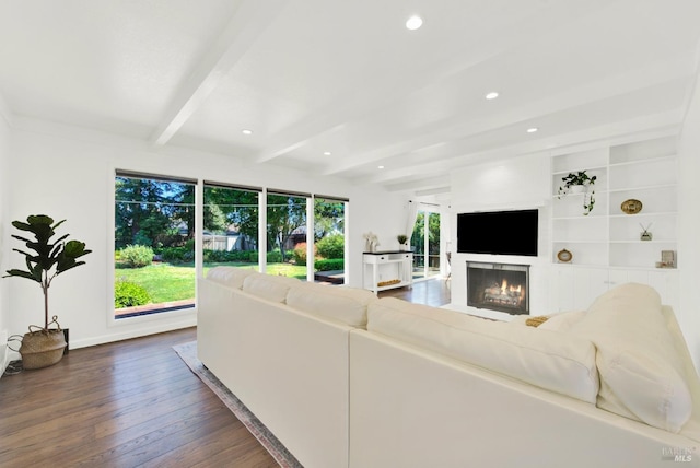 living room featuring a lit fireplace, baseboards, beam ceiling, dark wood-style floors, and recessed lighting