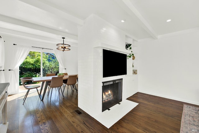 living area featuring beam ceiling, a fireplace, recessed lighting, and dark wood-style flooring