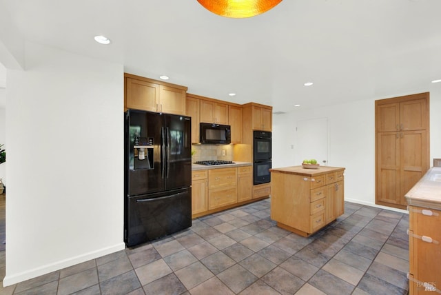 kitchen featuring a center island, baseboards, recessed lighting, backsplash, and black appliances