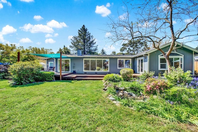 back of house with a lawn and a wooden deck