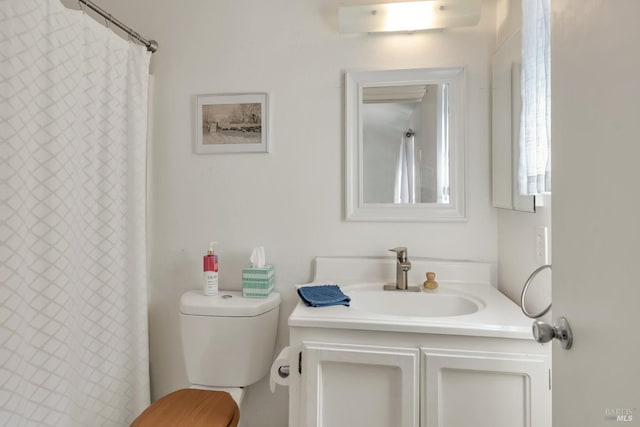bathroom featuring vanity, toilet, and a shower with curtain