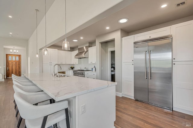 12 Rose Ct, Novato, CA 94945 - kitchen with high quality appliances, wall chimney range hood, a sink, dark wood-type flooring, and recessed lighting