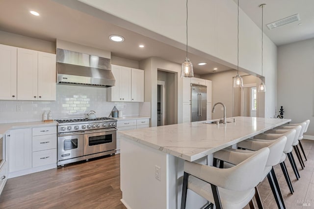 12 Rose Ct, Novato, CA 94945 - kitchen featuring high end appliances, wall chimney exhaust hood, a sink, wood finished floors, and backsplash