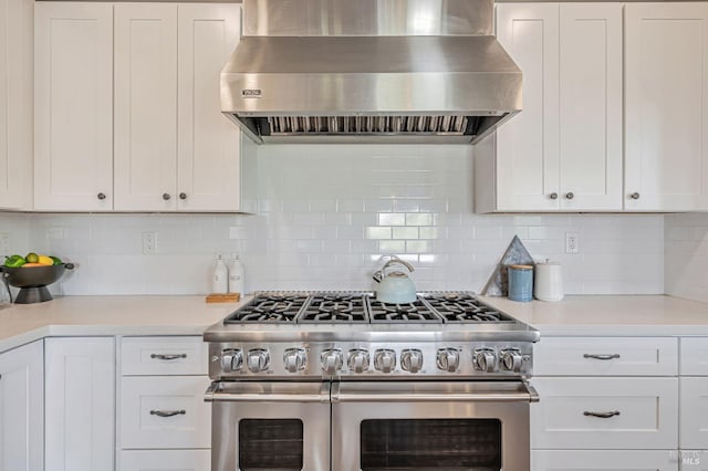 12 Rose Ct, Novato, CA 94945 - kitchen featuring double oven range, wall chimney range hood, light countertops, white cabinets, and backsplash