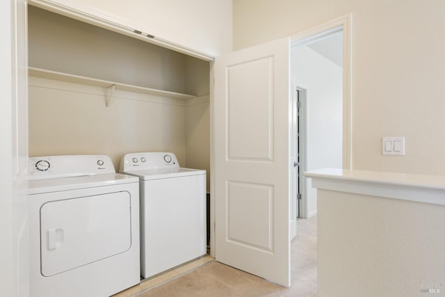 washroom with light colored carpet, washer and dryer, and laundry area