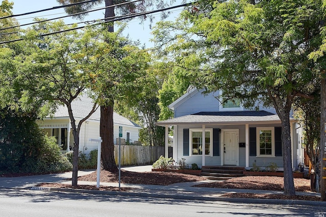 bungalow-style home with fence and a porch