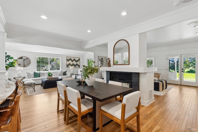 1030 Thompson Ln, Petaluma, CA 94952 - dining space featuring a multi sided fireplace, light wood-style floors, ornamental molding, and recessed lighting