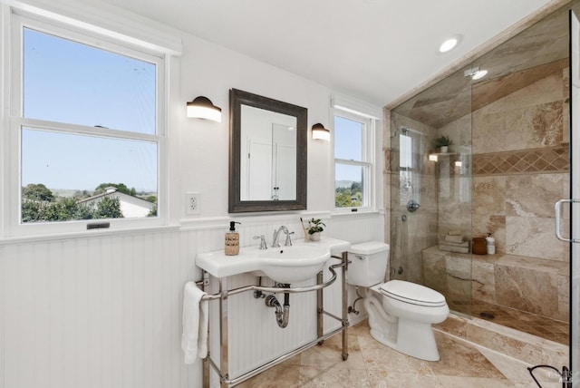 1030 Thompson Ln, Petaluma, CA 94952 - bathroom with toilet, a stall shower, healthy amount of natural light, and a wainscoted wall
