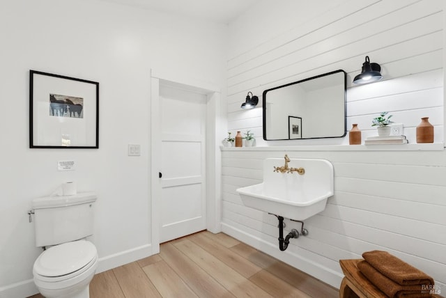 1030 Thompson Ln, Petaluma, CA 94952 - half bathroom featuring wood finished floors, toilet, and baseboards