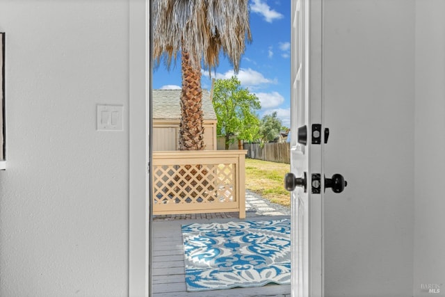 doorway to outside featuring a textured wall and plenty of natural light