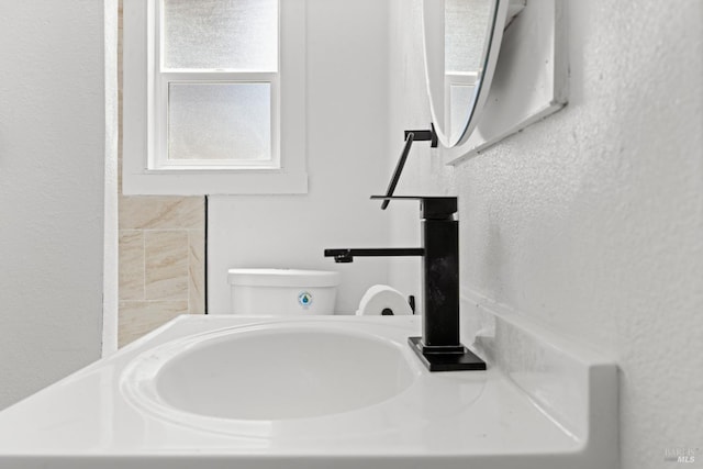 half bath featuring toilet