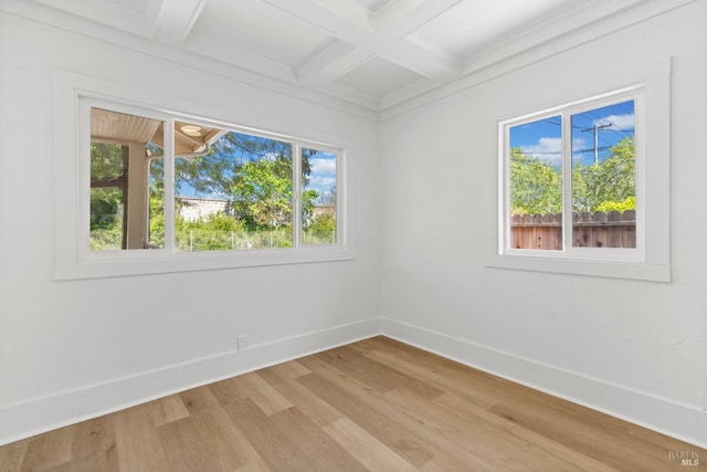 unfurnished room featuring beamed ceiling, light wood-style floors, baseboards, and coffered ceiling