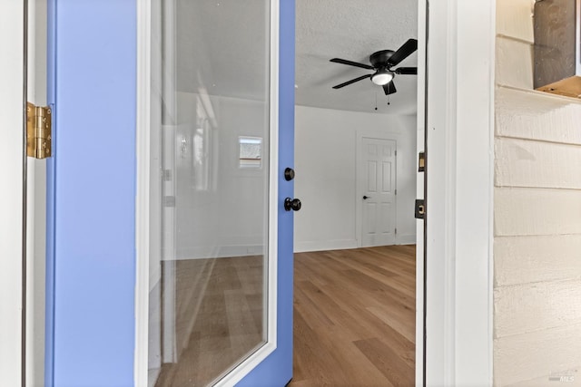 bathroom with wood finished floors and a ceiling fan