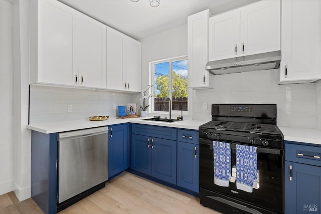 kitchen with a sink, dishwasher, blue cabinetry, under cabinet range hood, and gas stove