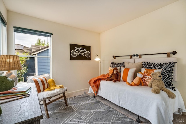 bedroom featuring baseboards and carpet
