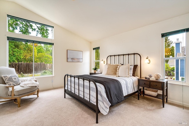 bedroom with light carpet, multiple windows, and baseboards