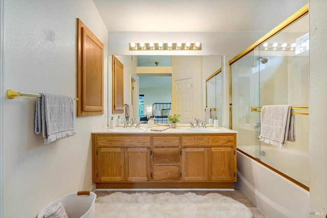 bathroom with enclosed tub / shower combo, a sink, and double vanity