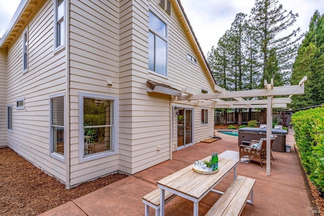 view of patio / terrace featuring a fenced backyard, a pergola, a hot tub, and outdoor dining area