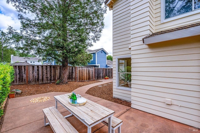 view of patio / terrace featuring fence