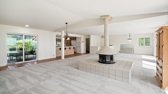 living room featuring recessed lighting, a chandelier, vaulted ceiling, and light carpet