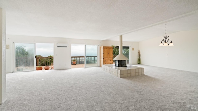 5750 Lichau Rd, Penngrove, CA 94951 - unfurnished living room featuring carpet floors, a wall mounted air conditioner, a wood stove, and a textured ceiling