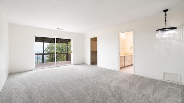 interior space with visible vents, a chandelier, and light colored carpet