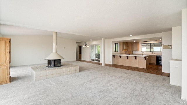 5750 Lichau Rd, Penngrove, CA 94951 - unfurnished living room featuring carpet flooring, recessed lighting, a wood stove, and a sink