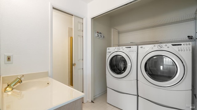 laundry room with washer and clothes dryer and a sink