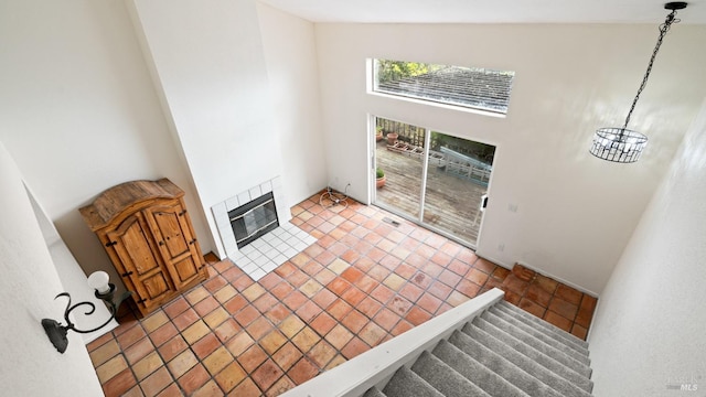 5750 Lichau Rd, Penngrove, CA 94951 - unfurnished living room featuring a high ceiling, heating unit, a fireplace, tile patterned flooring, and stairway