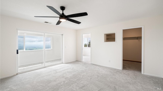 5750 Lichau Rd, Penngrove, CA 94951 - unfurnished bedroom featuring carpet floors, a walk in closet, baseboards, a ceiling fan, and a closet