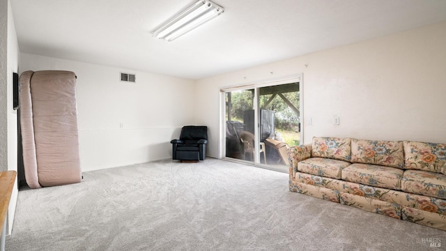 carpeted living area featuring visible vents
