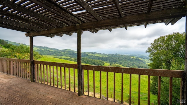 wooden deck featuring a pergola and a yard