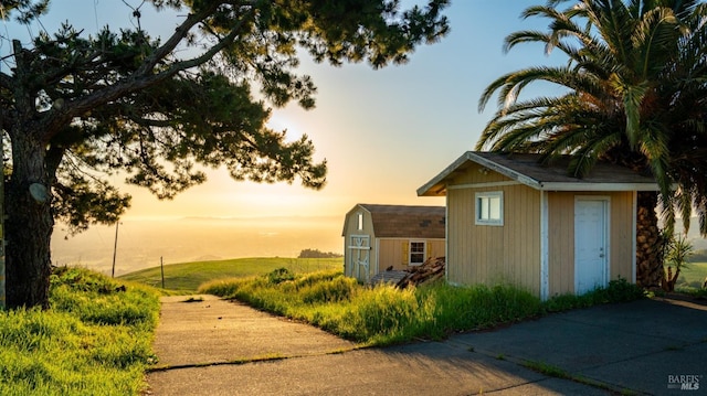 outdoor structure at dusk with an outdoor structure and a storage shed