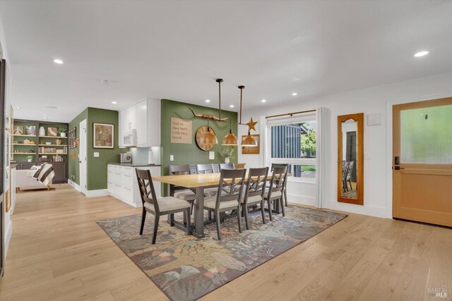 dining area featuring recessed lighting, light wood-style floors, and baseboards