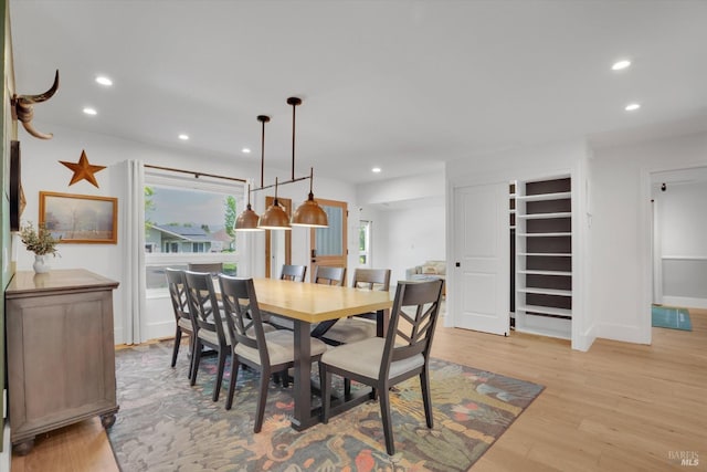 dining area featuring baseboards, light wood-type flooring, and recessed lighting