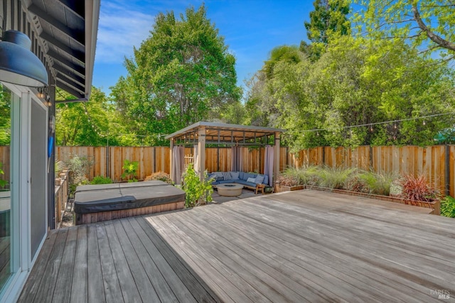 wooden terrace with a fenced backyard, an outdoor hangout area, and a gazebo