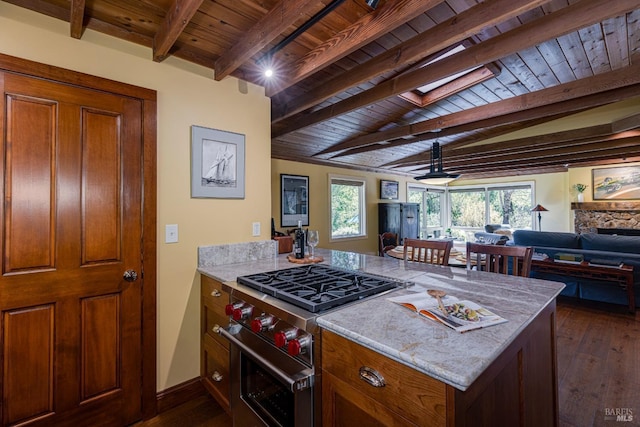 kitchen featuring beamed ceiling, open floor plan, wood ceiling, and high end stainless steel range oven