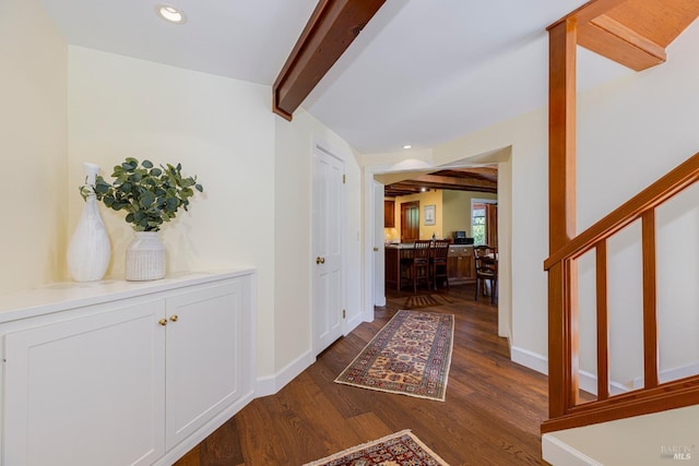 corridor with beamed ceiling, dark wood finished floors, baseboards, and recessed lighting