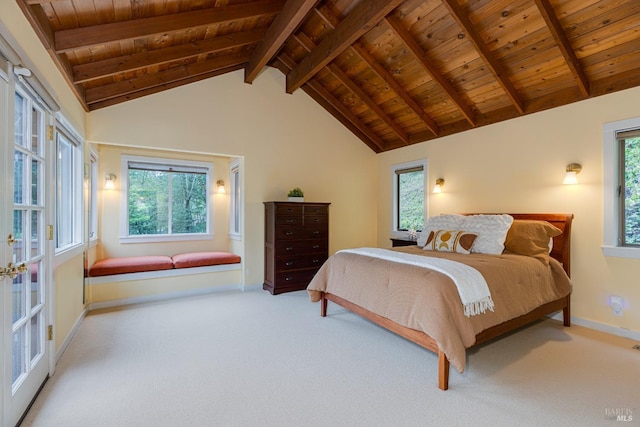carpeted bedroom featuring baseboards, vaulted ceiling with beams, and wooden ceiling