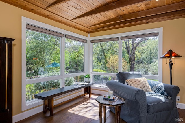 sunroom / solarium featuring baseboards, wood finished floors, wood ceiling, and beamed ceiling