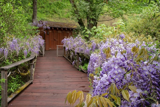 wooden terrace with an outbuilding and a shed