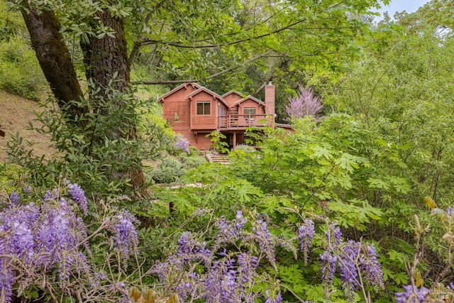 view of yard with a view of trees and a deck