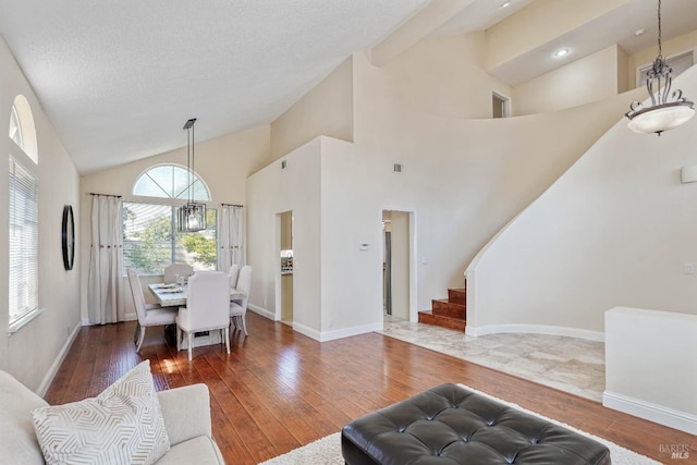 1006 Armsby Way, Suisun City, CA 94585 - living room with hardwood / wood-style flooring, stairway, high vaulted ceiling, baseboards, and recessed lighting