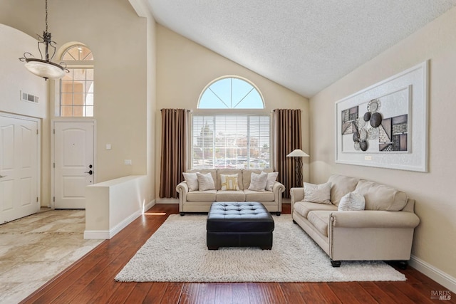 1006 Armsby Way, Suisun City, CA 94585 - living room with high vaulted ceiling, a textured ceiling, hardwood / wood-style flooring, and baseboards